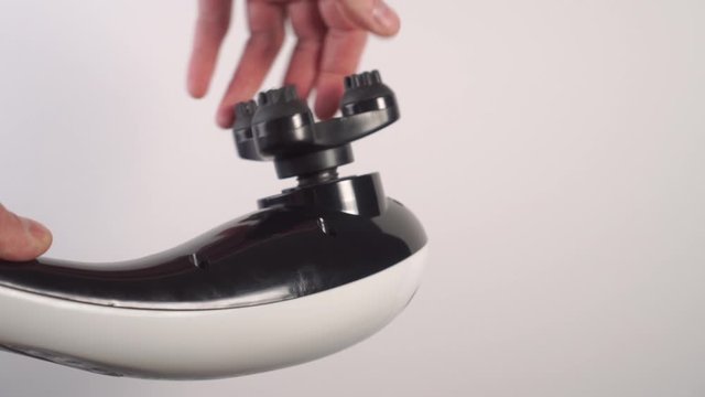 Mounting the embossed nozzle of the vibratory massager in black and white. Selection of individual massage equipment