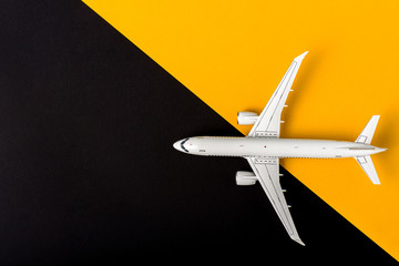 Aircraft model on yellow and black background, Top view with empty space. Concept of aircraft industry, airline safety, security