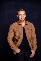 man in a brown shirt on a black background.