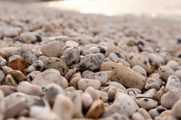 wet stones on the sea shore  in the sunset. soft focus. blur