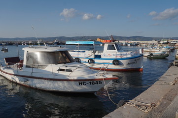 Fototapeta premium Fishing boats moored on the pier, summer day.