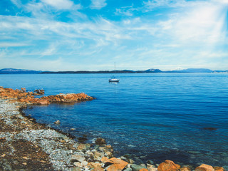 Seagulls and the boat at the rocky shore