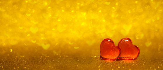 Romantic and Love banner with two red hearts on shiny gold bokeh background. Copyspace. Valentines Day concept.