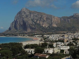 Fototapeta na wymiar San Vito lo Capo – panorama of the white town, the turquoise sea, the white beach and the rocky peak in the background