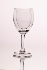 Two wine glasses isolated on a white background. The optical effect of a glass in a glass