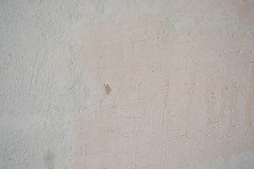 Light old wall without a ceiling. Grunge gray wall. Background texture of putty wall.