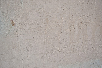 Light old wall without a ceiling. Grunge gray wall. Background texture of putty wall.