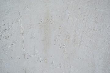 Light old wall without a ceiling. Grunge gray wall. Background texture of putty wall.