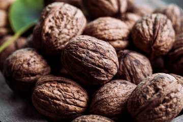 Walnuts with and without shells (filling the picture). Background of fresh walnuts.