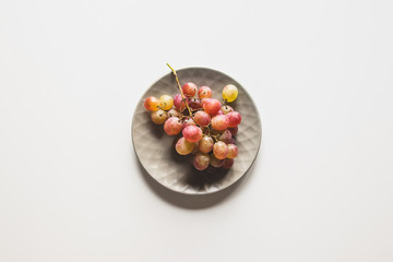 Isolated grapes. Red grape in a bowl isolated on white background