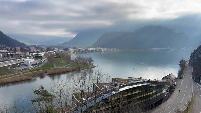 Timelapse lake with mountains panorama. Traffic on the Highway. Stansstad. Canton Nidwalden. Switzerland.