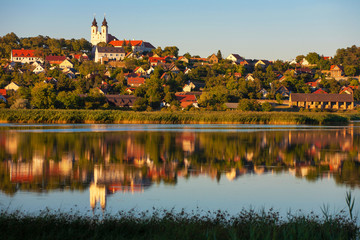 Tihany village and the Benedictian abbey in warm sunset colors with the inner lake in the front and...