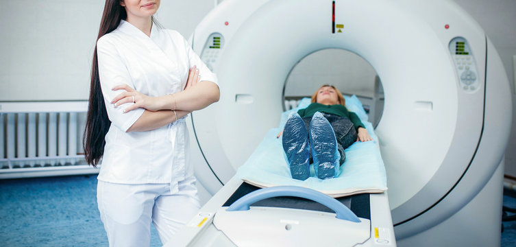 Doctor analyzes the patient on CT Scan in modern hospital