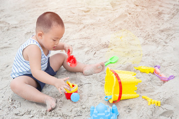 Healhty little boy playing a sand toy on the beach