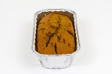 One loaf of pumpkin bread sitting vertical with a white background