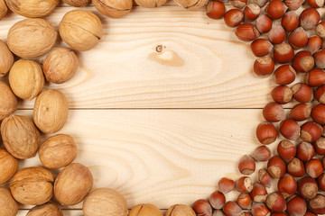 Frame of nuts on a background of wooden boards