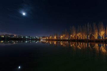 Fototapeta na wymiar Dark city landscape of lake and moon