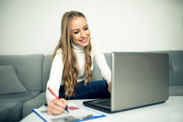 Young woman using paying bills online