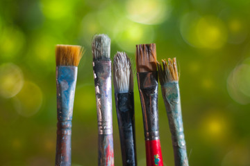  art color mixing artist brushes and blurred landscape background © Francis