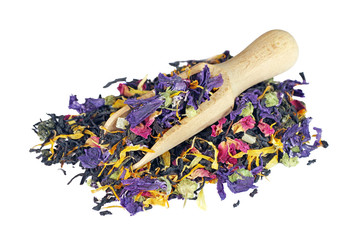 heap of tea leaves and flower petals isolated on a white. blended tea in a scoop close up.