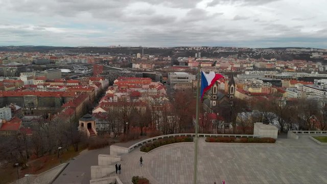 Czech Country Flag Waving on Vitkov Hill, Prague, Twilight Aerial View on Karlin and Florenc District Under Dramatic Sky