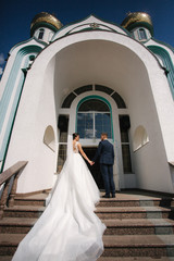 Obraz na płótnie Canvas Firtst look of groom and bride by the church