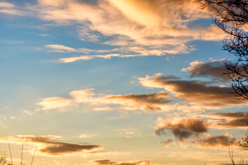  Bright sunset on the background of cloudy sky.