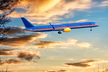 Fototapeta na wymiar Big blue aeroplane jet is taking-off on background of sunset.