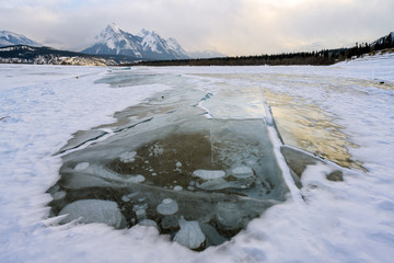 Trapped methane bubbles frozen into the water under the thick cracked and folded ice on Abraham Lake, located in the Kootenay Plains area of the Canadian Rockies, western Alberta, Canada