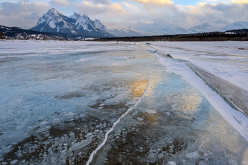 Trapped methane bubbles frozen into the water under the thick cracked and folded ice on Abraham Lake, located in the Kootenay Plains area of the Canadian Rockies, western Alberta, Canada