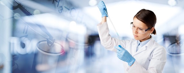 Young female scientist standing on background