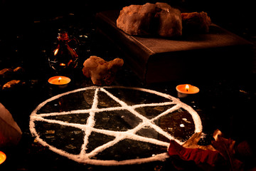 Pentagram made of salt, a pagan symbol used for protection by the wiccan community,  surrounded by...