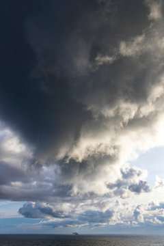 Picturesque dramatic stormy Cumulonimbus Calvus cloud formation over the Baltic sea near Helsinki, Finland. Landscape with dramatic sky over the sea