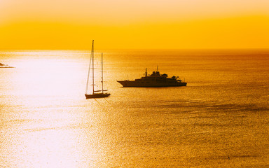 Sunrise or sunset with yachts at Porto Rotondo on at Mediterranean sea in Sardinia island of Italy....