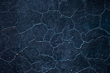 Empty ink blue dark background element with cracked and perched irregular texture.