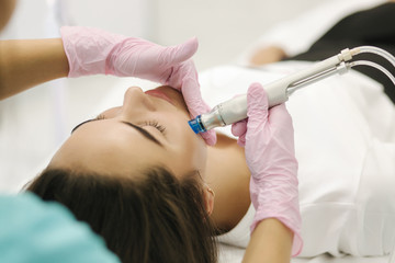 First-person view of cosmetologist doing beauty procedure at cosmetology clinic