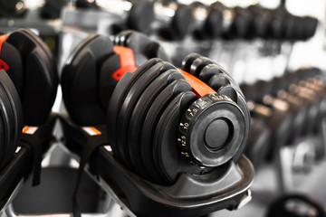 Fototapeta na wymiar Close up dumbells set for a exercise in the fitness gym.