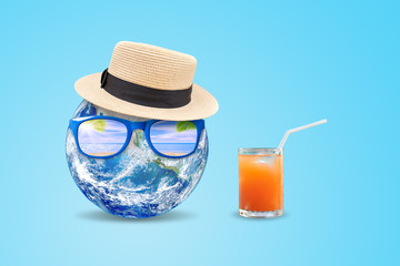 Summer Vacation and Holiday Concept : Blue planet earth wear weave hat and sunglasses with orange juice put on blue background. (Elements of this image furnished by NASA.)