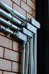Electrical wiring work in a steel pipe of a house with a loft style decoration design.
