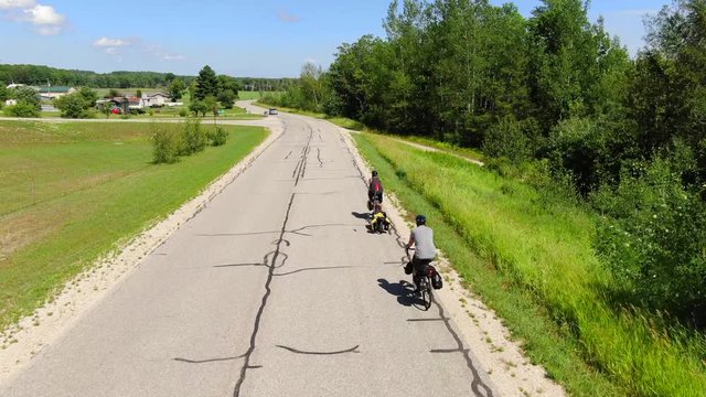 Cycle Touring Road Bikes to Backpacking Camping Travel Trail to Bois Blanc Island and Mackinac Island Country Roads fallowing cyclists down old road