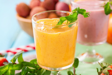 Orange persimmon blueberry smoothie   and fruits. Selective focus. Copy space. Top view