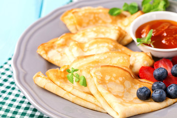 Pancakes with jam and berries on a table. Selective focus.  Copy space.