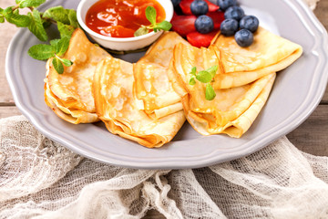Pancakes with jam and berries on a table. Selective focus.  Copy space.