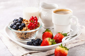 Breakfast - muesli, berries and coffee. Selective focus. Copy space