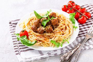 Spaghetti with meat balls in a plate on a table. Selective focus. Copy space
