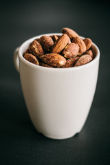 Closeup Salt Roasted Almond in a white cup.