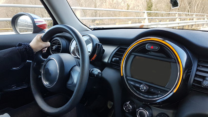 Fototapeta premium steering wheel drivers hands and modern black car