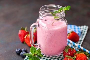 Smoothie in a jar and berries on a table. Selective focus. Copy space.