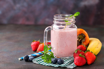 Smoothie in a jar and berries on a table. Selective focus. Copy space.