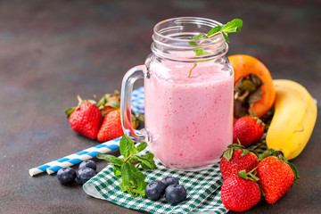 Smoothie in a jar and berries on a table. Selective focus. Copy space.